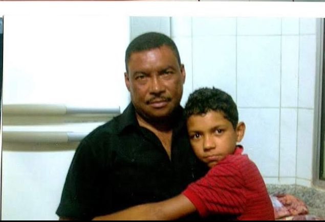 Young Daniel as a child being held by his grandfather